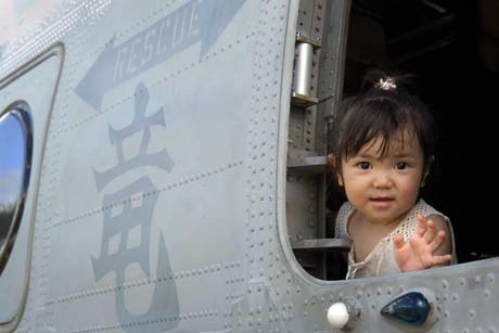 Yua Nakamoto, 2, looks out the window of a CH-46E Sea Knight helicopter during the Marine Corps Community Services Camp Kinser Festival, Sunday.